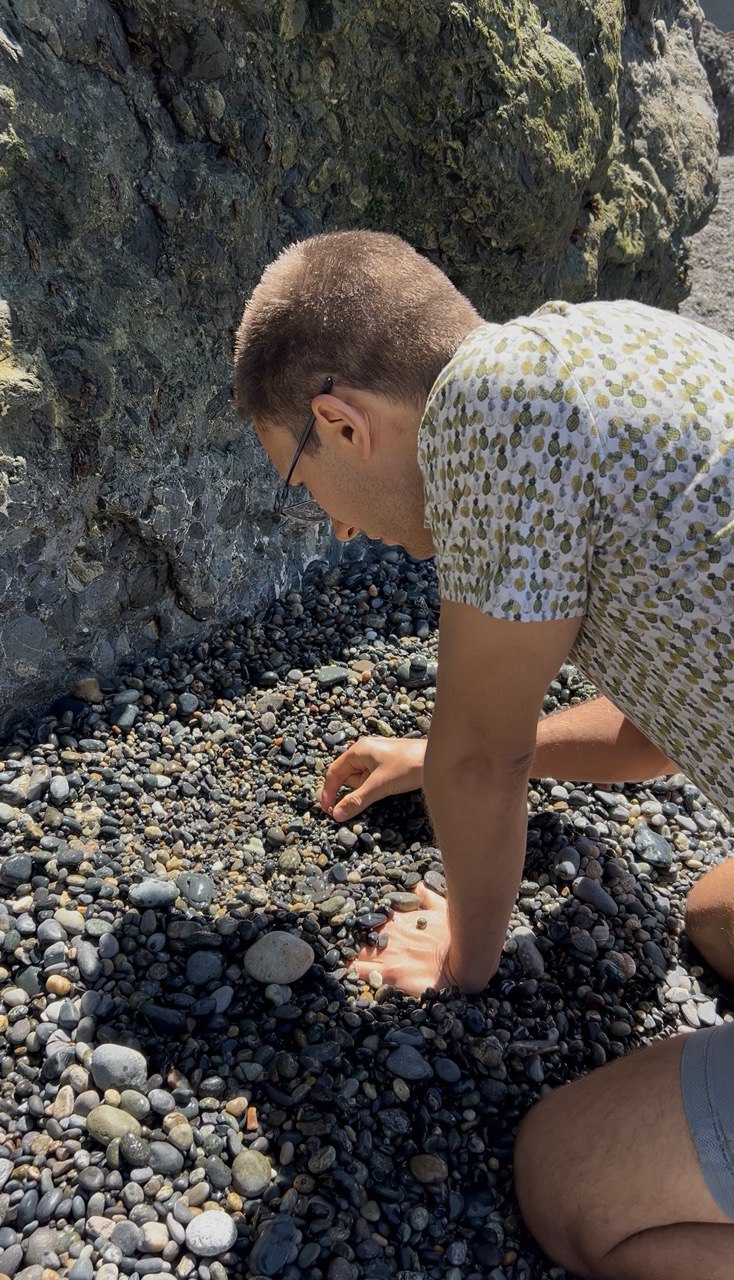 Michael searching for stones along a Vancouver Island shoreline