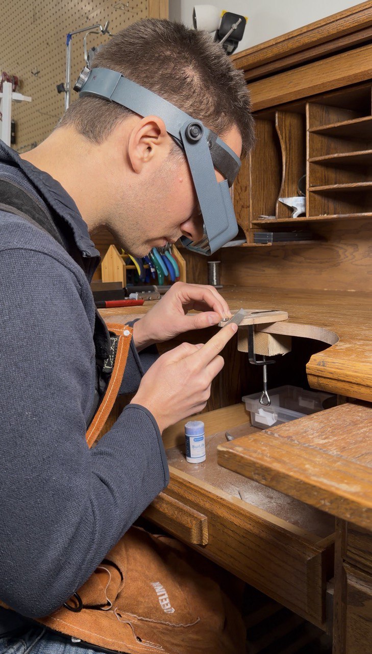 Michael at the jeweller's bench with optivisor, working on a piece