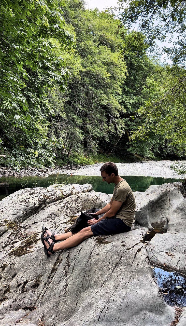 Michael and Eli exploring a Vancouver Island river, searching for stones