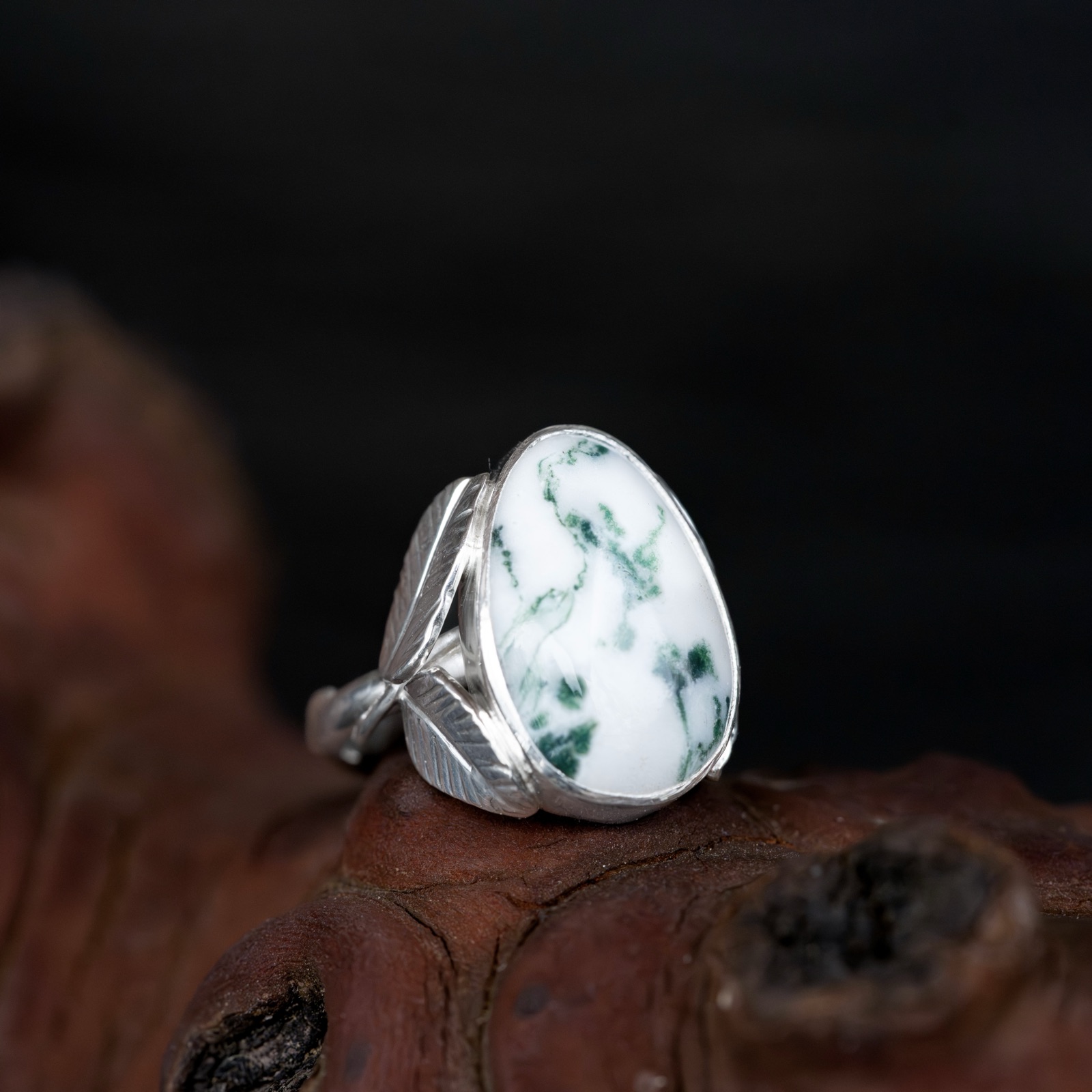 Vine leaf ring displayed on driftwood